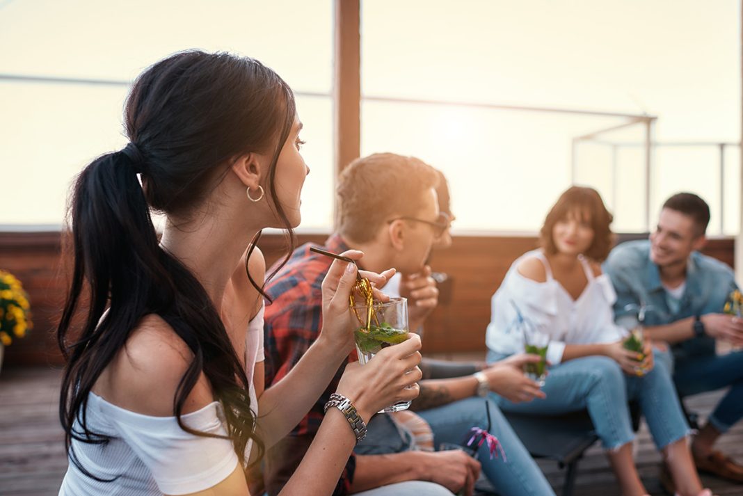 Young people drinking on a rooftop bar